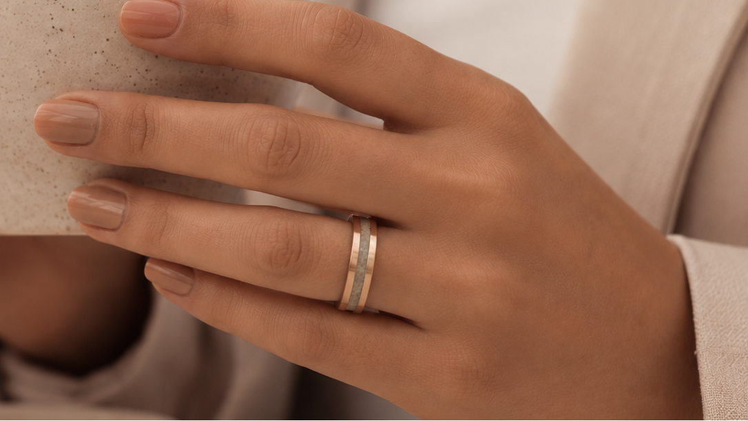 Gold Inlay Memorial Ring on a woman's hand as she holds a stoneware cup